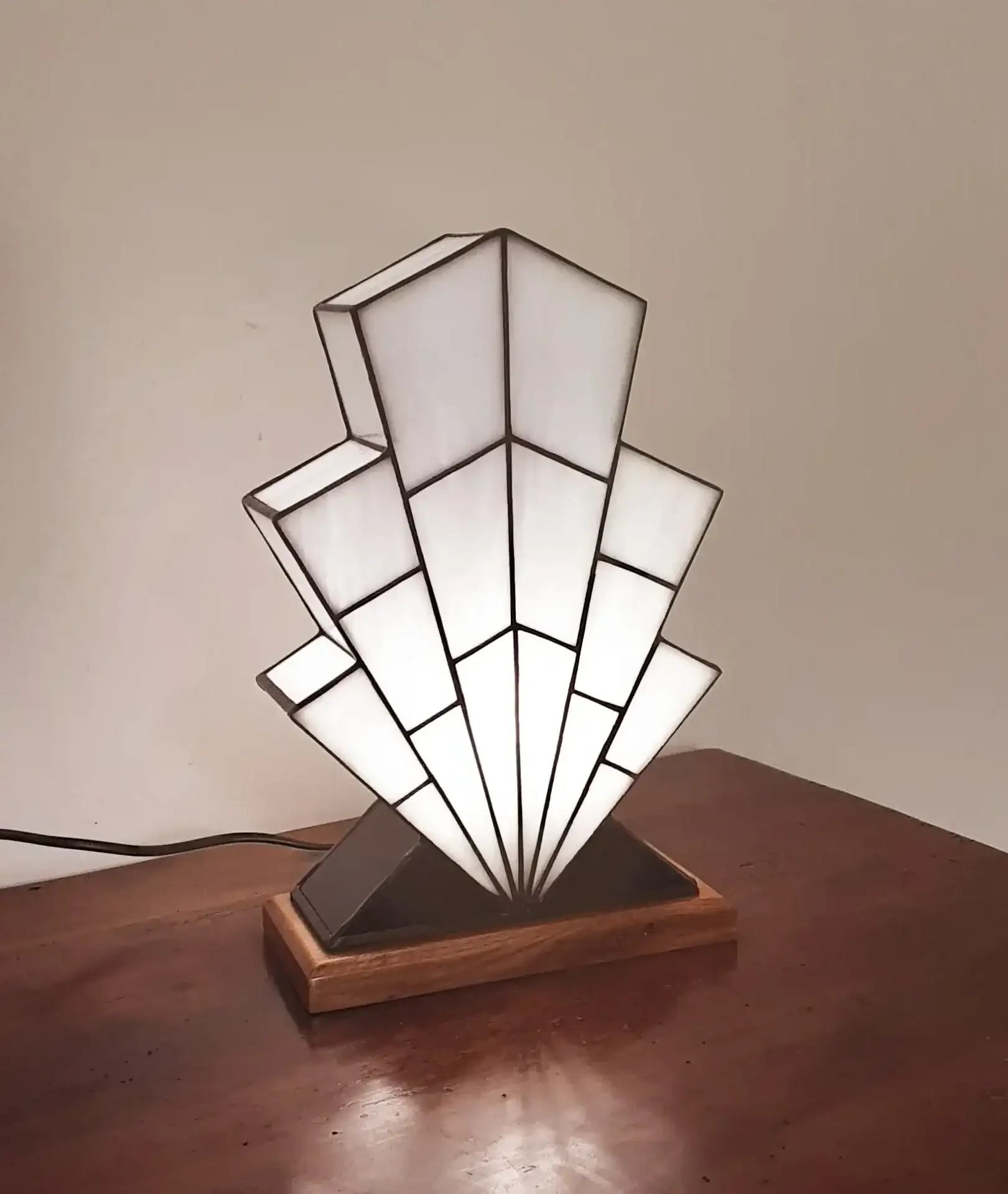 Lampe Art Déco en vitrail opalescent blanc, pied en verre noir et socle en chêne massif sculpté.