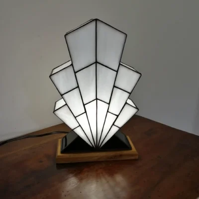 Lampe Art Déco en vitrail opalescent blanc, pied en verre noir et socle en chêne massif sculpté.